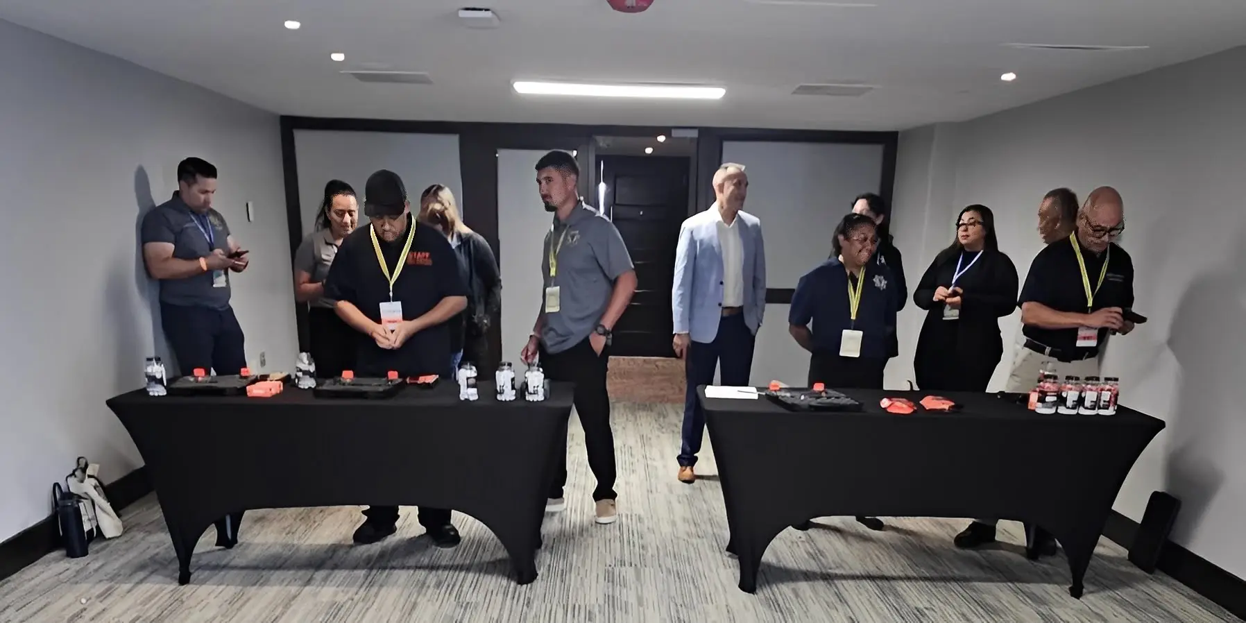 People at tables with products in conference.