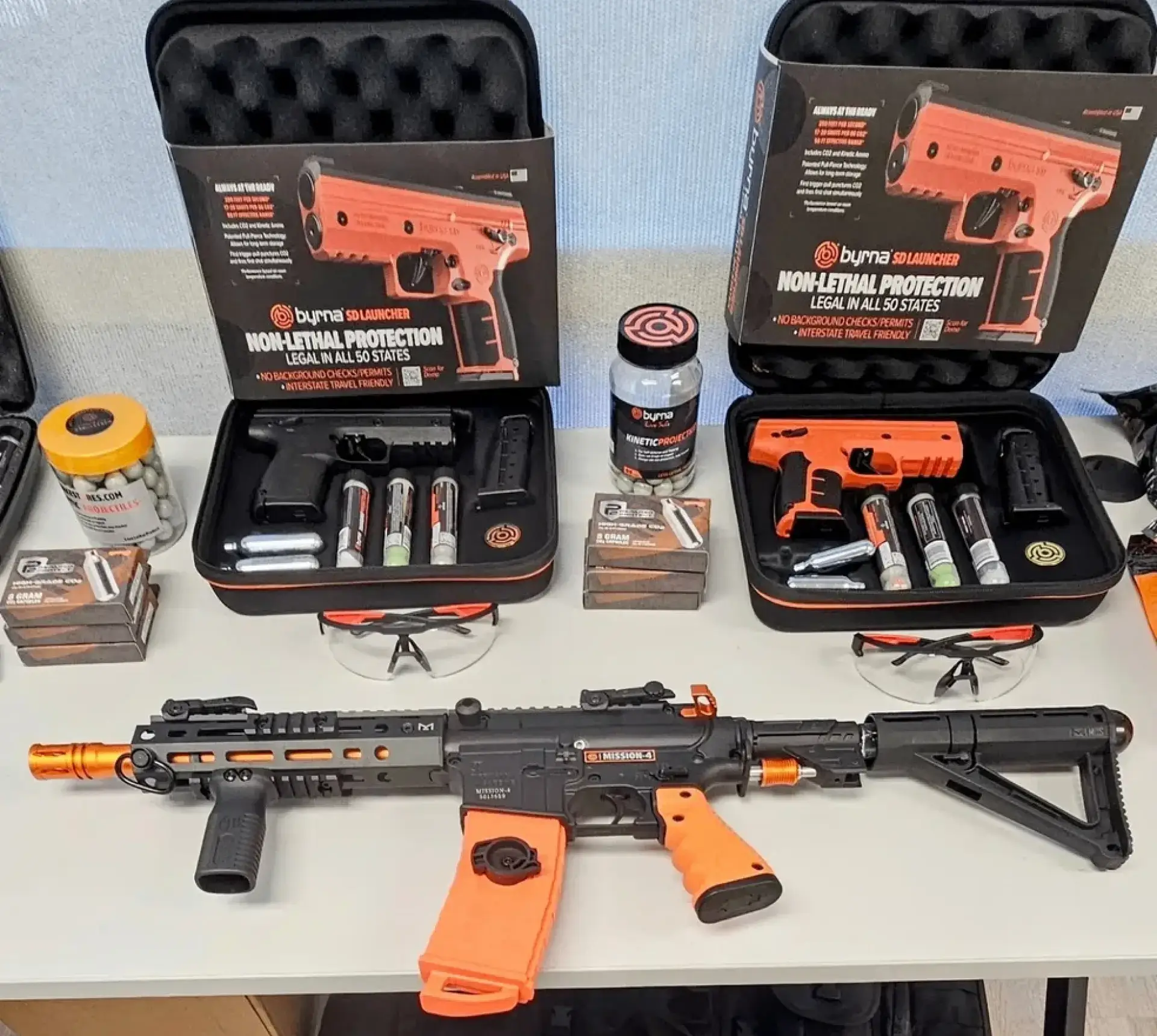 Non-lethal protection kits and equipment display.