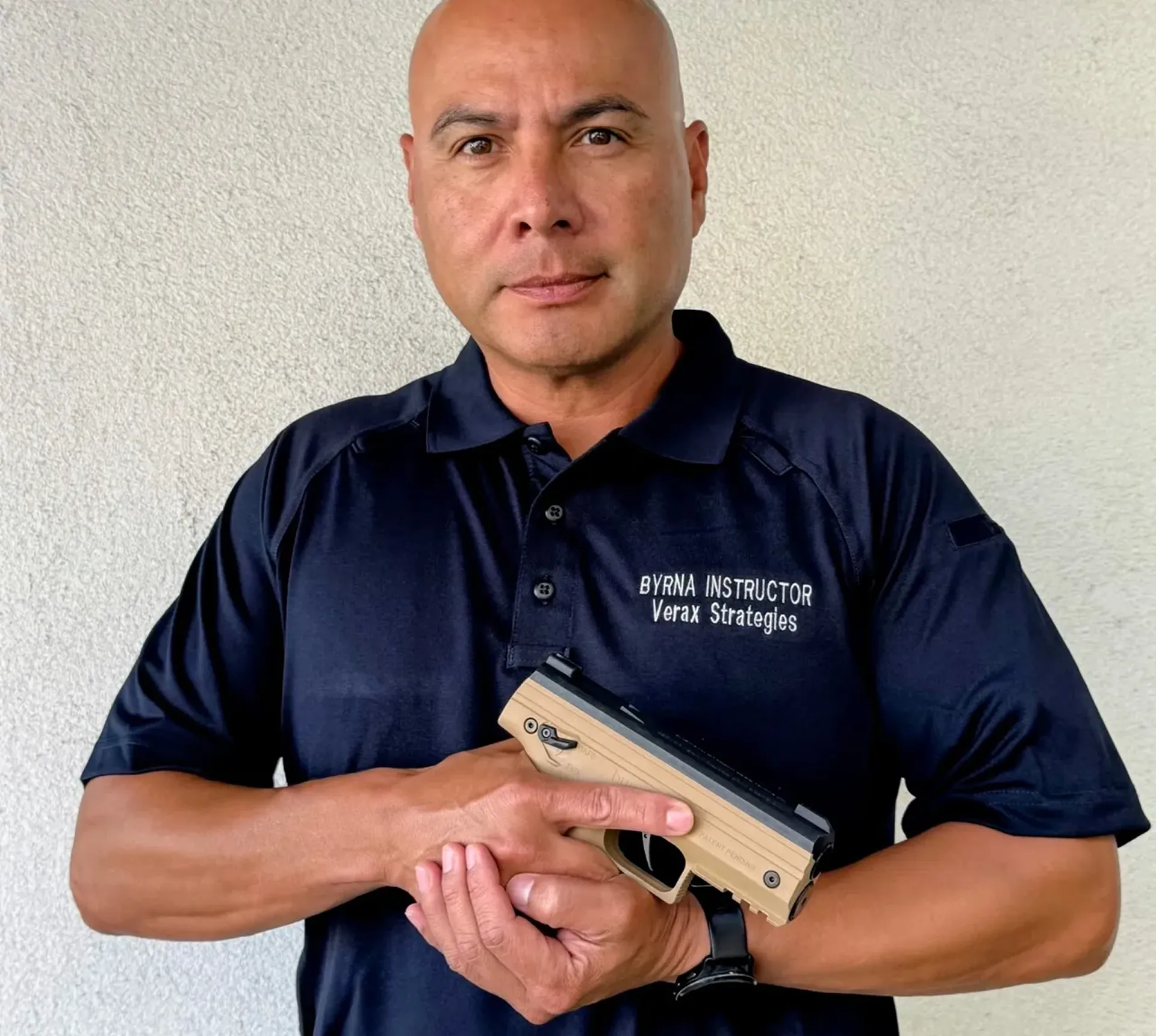 Man holding a training pistol, wearing uniform.