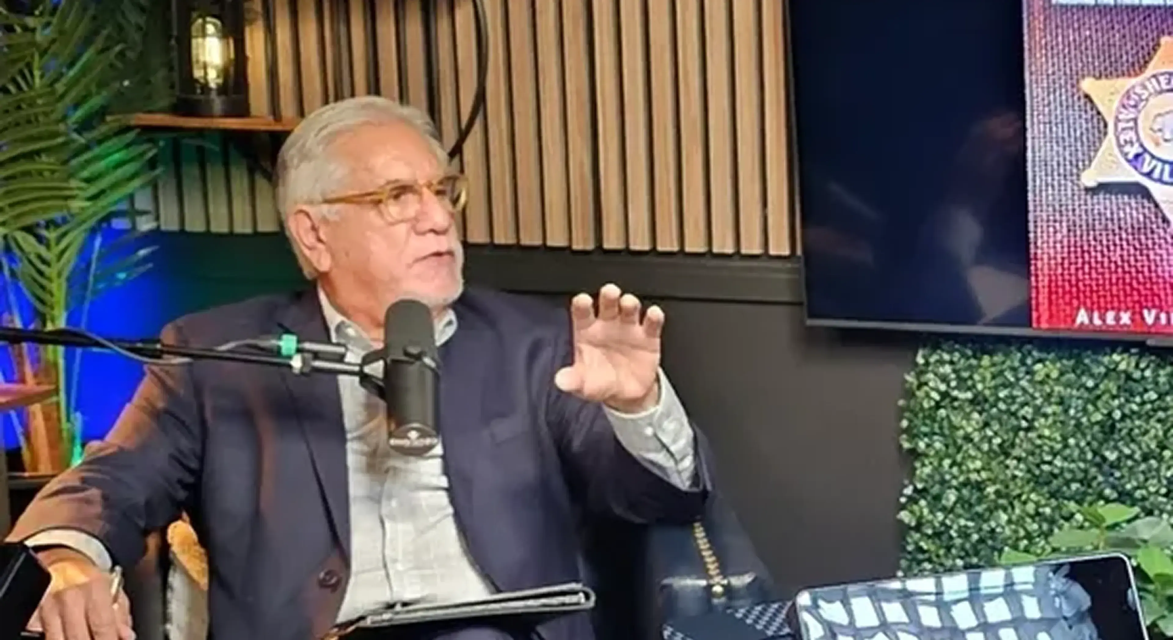 Man speaking into microphone during podcast recording.