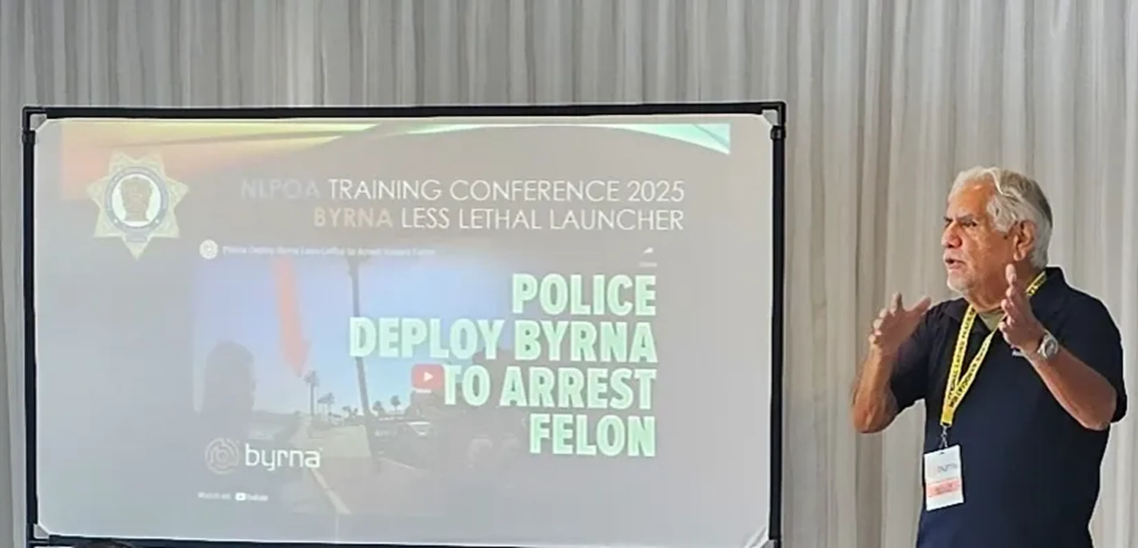 Man presenting at police training conference.