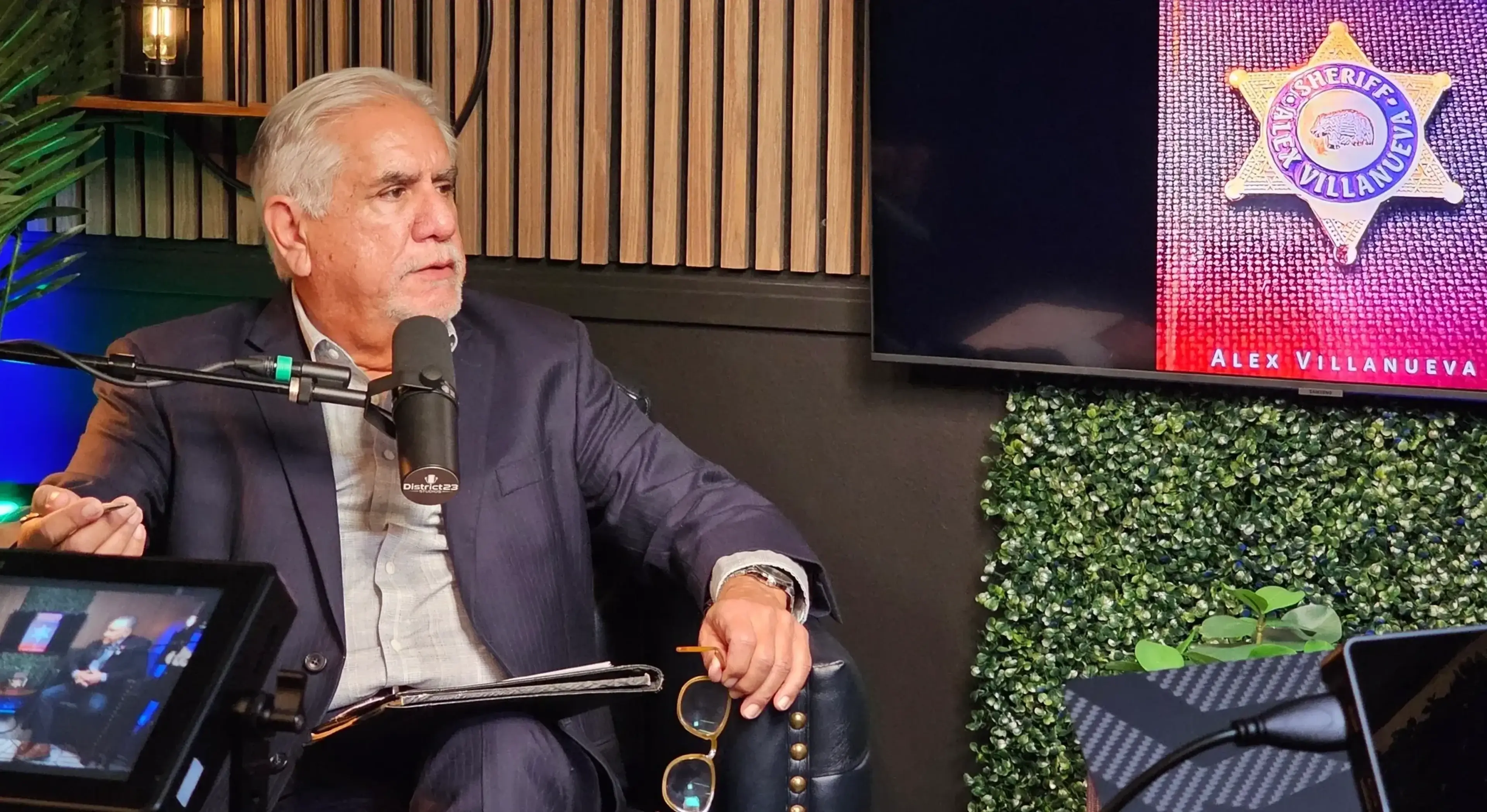 Man speaking in a podcast studio setting.