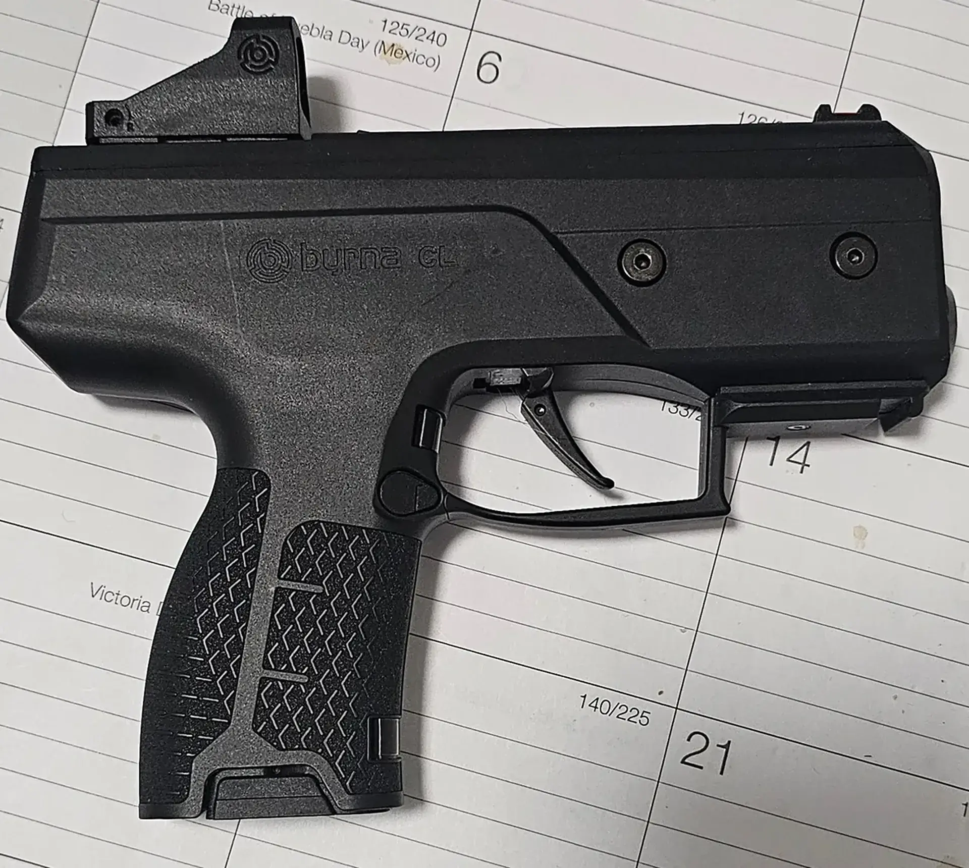 Black handgun on a calendar page.