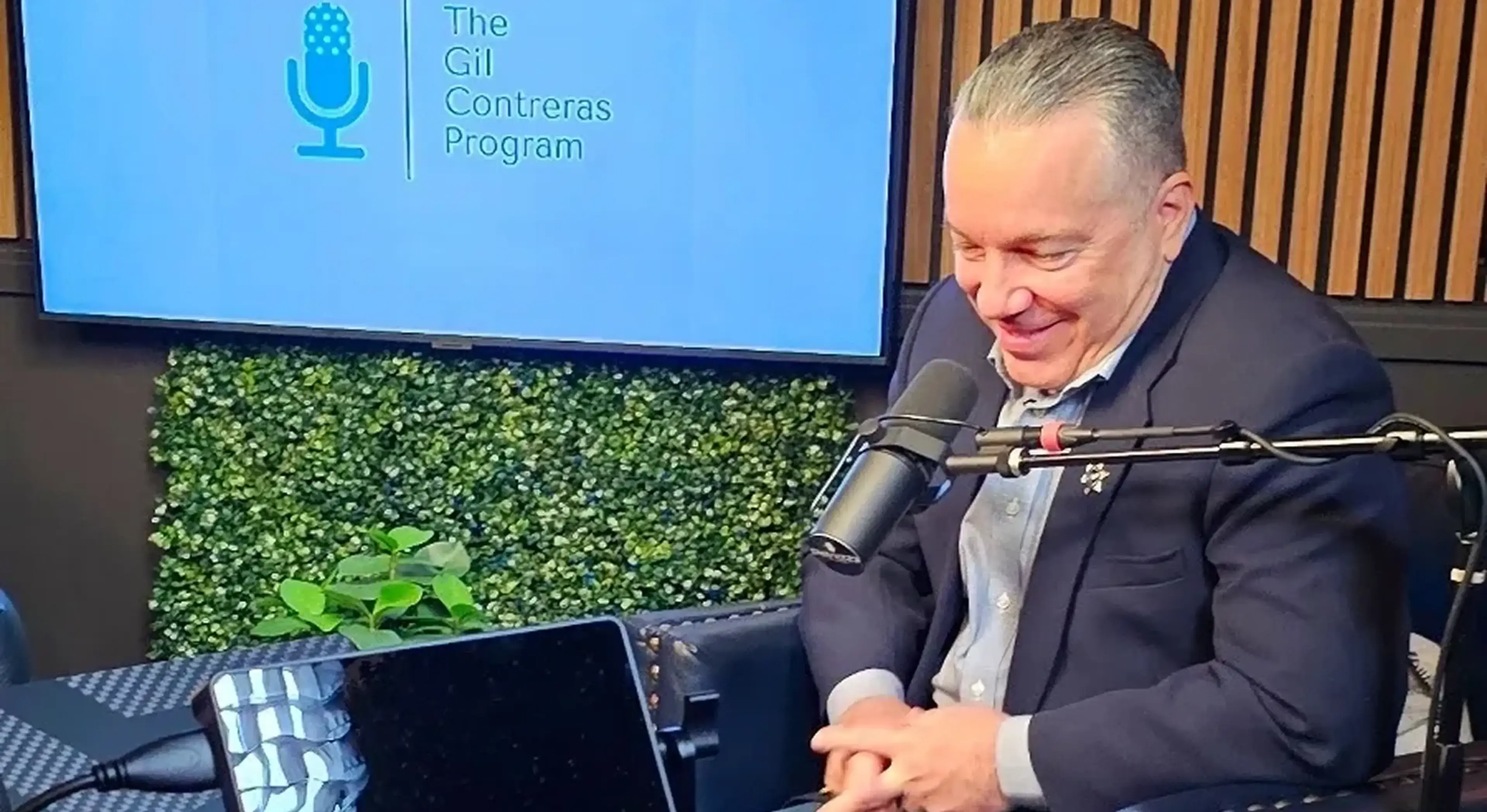 Man speaking into microphone during podcast recording.