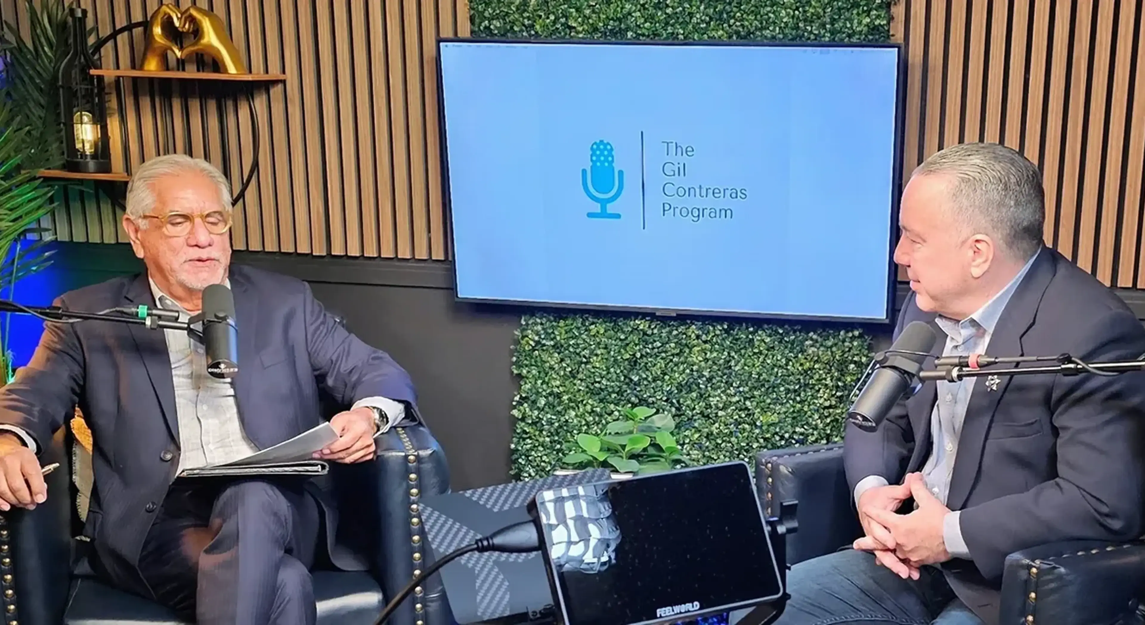 Two men recording a podcast discussion.