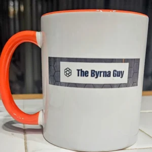 White mug with "The Byrna Guy" logo.
