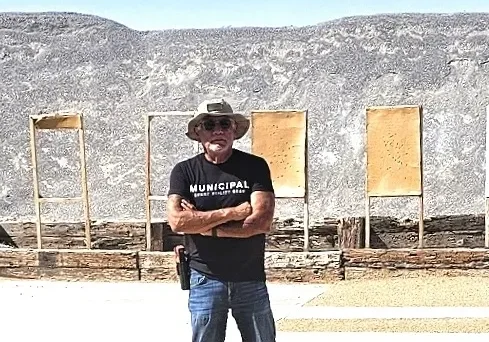 Man standing outdoors in casual attire.