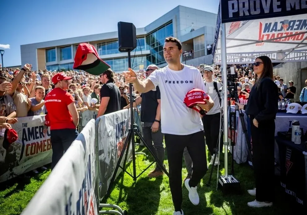 Man tossing hat at outdoor event.